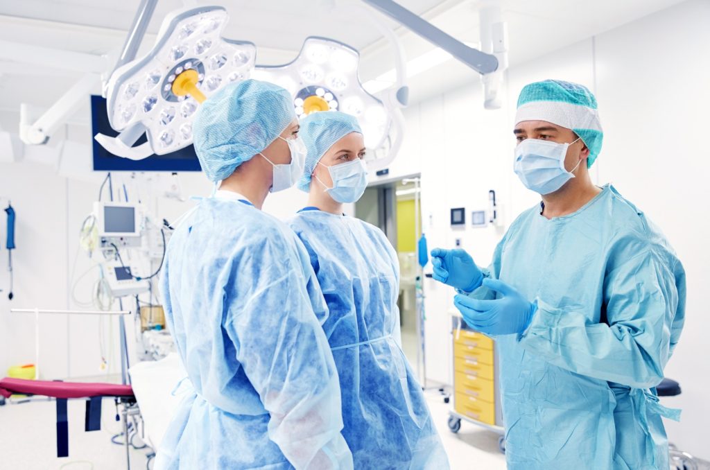 group of surgeons in operating room at hospital