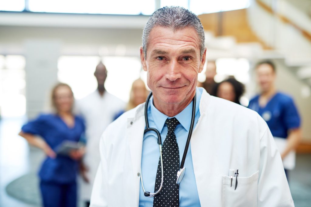 Portrait of adult cheerful doctor in hospital